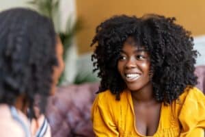 smiling teenage girl who is excited to learn about a teen summer mental health program in Omaha, NE