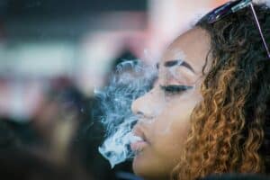 teen girl exhaling smoke